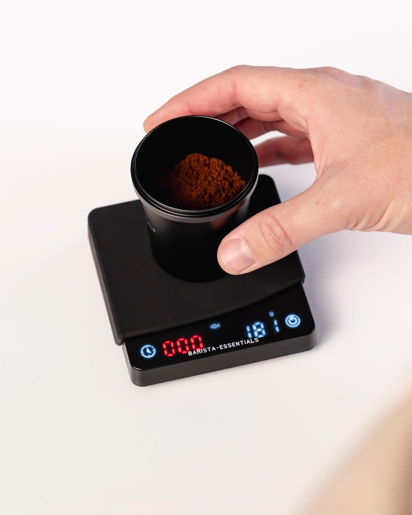 Barista-Essentials mini coffee scale with measuring cup on the scale