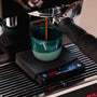 Mini coffee scale on La Marzocco with espresso cup under naked portafilter Barista Essentials