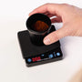 Barista-Essentials mini coffee scale with measuring cup on the scale