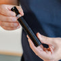 Man pulls glass spray bottle from RDT spray holder by Barista-Essentials
