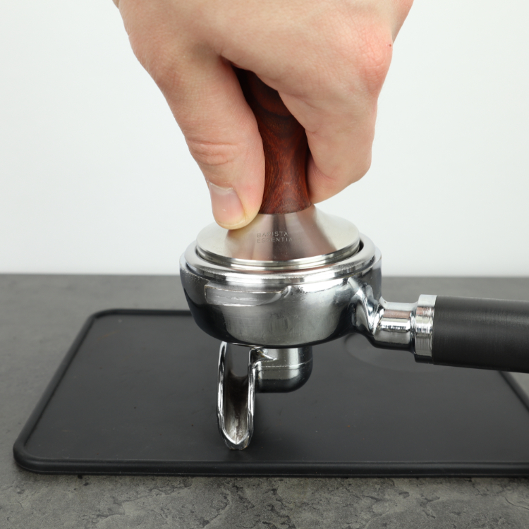 Aantampen van koffie met tamper rancilio houten handvat